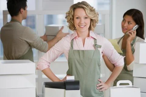 Multi-ethnic bakery workers behind counter Stock Photos