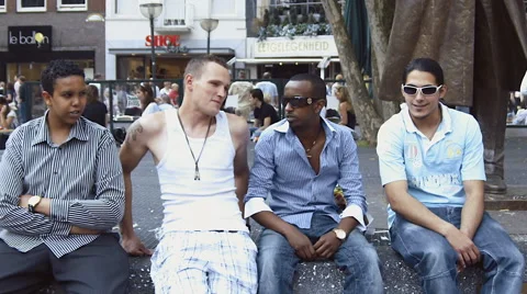 Multi-ethnic boys relaxed slow motion, city center Netherlands Stock Footage 57316541