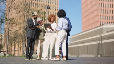 Multi-ethnic business people using digital tablet outdoors Stock Footage 257301404