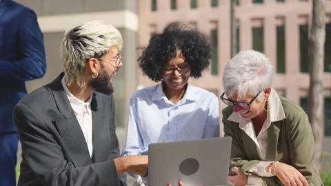 Multi-ethnic business people using laptop outdoors in the street Stock Footage 261419340