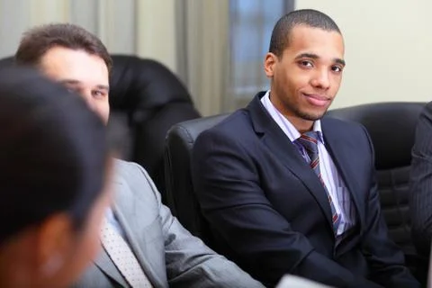 Multi ethnic business team at a meeting. focus on african-american young man Stock Photos