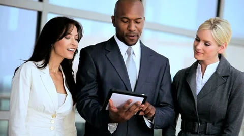 Multi Ethnic Business Team Using Wireless Tablet Stock Footage 7904057