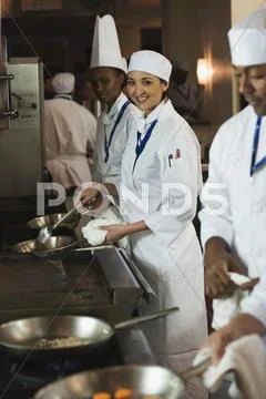 Multi-ethnic chefs preparing food Stock Photos