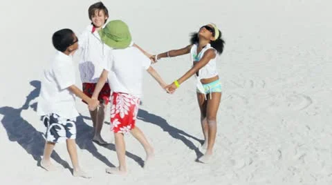 Multi ethnic children playing hands together on a beach Stock Footage 22226921