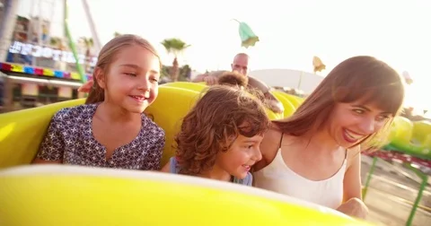 Multi-ethnic children riding roller coaster ride at amusement park 動画素材 81932516