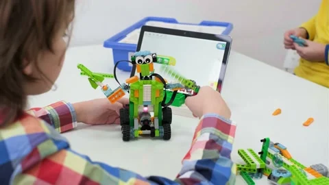 Multi ethnic children at technology lesson coding robot on tablet Stock Footage 169945223