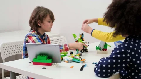 Multi ethnic children at technology lesson coding robot on tablet Stock Footage 170258817