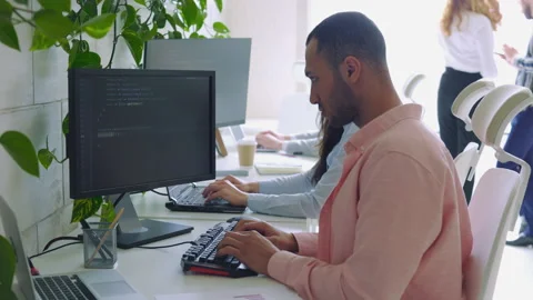 Multi Ethnic Computer Programmer Writing a Code in an Office. Stock Footage 256190651