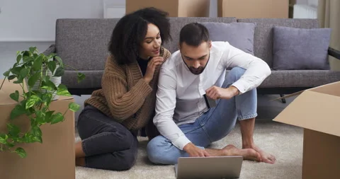 Multi-ethnic couple curly-haired girl and Caucasian bearded man making online Stock Footage 147008150