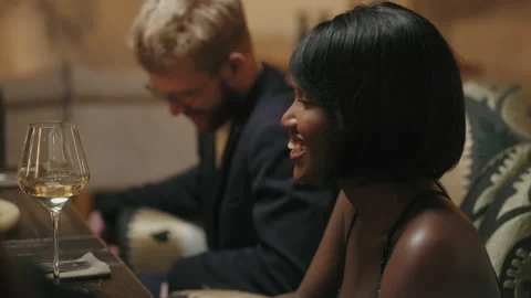 Multi ethnic couple dining with friends in restaurant, happy black woman and her Stock Footage 227936628