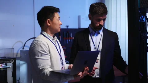 Multi-ethnic couple of electronic engineer and caucasian boss using computer Stock Footage 153744813