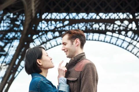 Multi-ethnic Couple Having Fun In Paris Near Eiffel Tower Fotos Stock