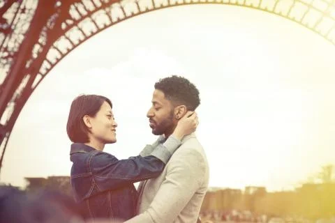 Multi-ethnic Couple Having Fun In Paris Near Eiffel Tower 写真素材