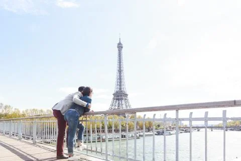 Multi-ethnic Couple Having Fun In Paris Near Eiffel Tower Stock Photos