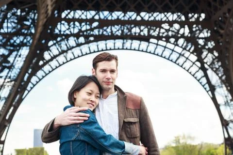 Multi-ethnic Couple Having Fun In Paris Near Eiffel Tower 写真素材