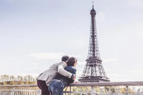 Multi-ethnic Couple Having Fun In Paris Near Eiffel Tower Stock Photos