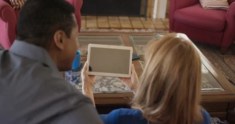 Multi Ethnic couple holding tablet computer with blank screen for compositing Stock Footage 117365868