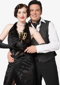 Multi-ethnic couple holding tango trophy Stock Photos