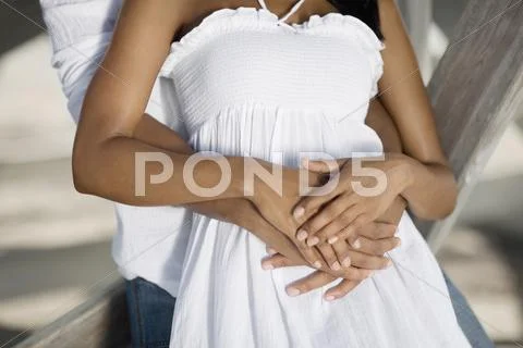 Multi-ethnic couple hugging Stock Photos