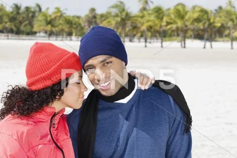 Multi-ethnic couple hugging Stock Photos