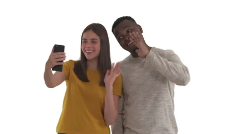 Multi-ethnic couple talking with friends or relatives by video call. Greeting Stock Footage 140723787