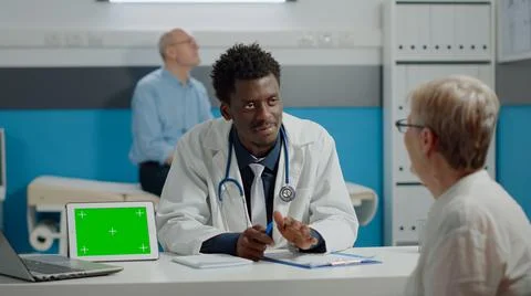 Multi ethnic doctor and old patient doing checkup with green screen Stock Photos