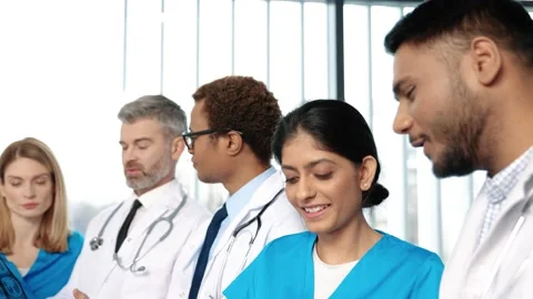 Multi ethnic doctors, men and women, talking and discussing diagnosis in clinic Stock Footage 148185534