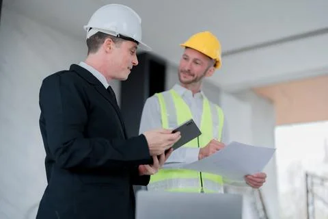 Multi ethnic engineer brainstorming and measuring for cost estimating on Stock Photos
