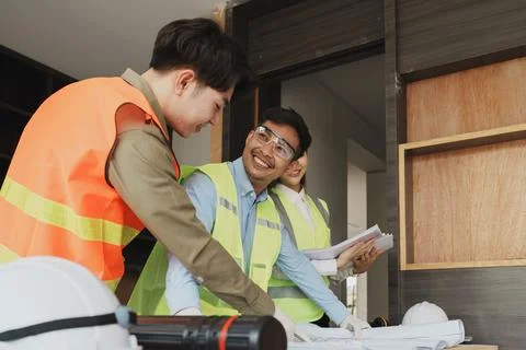 Multi ethnic engineer brainstorming and measuring for cost estimating on Stock Photos