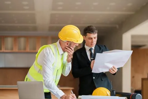 Multi ethnic engineer brainstorming and measuring for cost estimating on Stock Photos