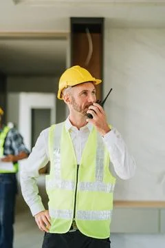 Multi ethnic engineer brainstorming and measuring for cost estimating on bl.. Stock Photos