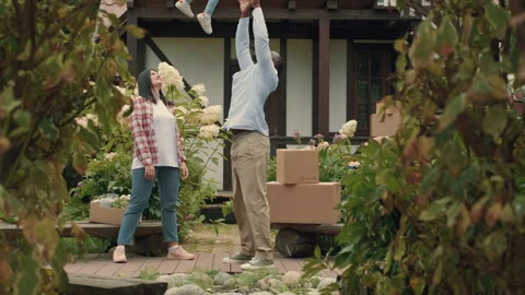 A multi-ethnic family is playing while moving into a new purchased house Stock Footage 210518764
