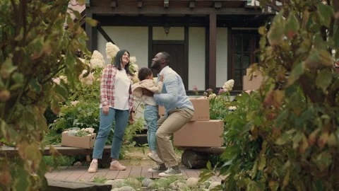 A multi-ethnic family is playing while moving into a new purchased house Stock Footage 210520984