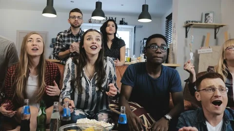 Multi-ethnic fans go crazy celebrating goal on TV. Passionate football Stock-Footage 87804637
