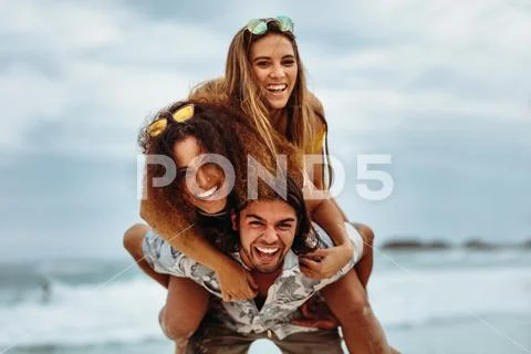 Multi-ethnic friends enjoying summer holidays on beach Stock Photos
