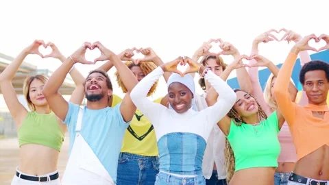 Multi-ethnic friends gesturing a heart shape with hands outdoors Stock Footage 263616283