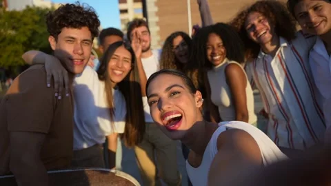 Multi-ethnic friends gesturing success while taking selfie in the city Stock Footage 301076744