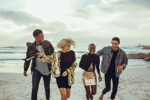 Multi-ethnic friends having fun on the beach Stock Photos