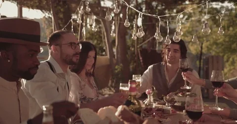Multi-ethnic friends having lunch party at vineyard winery and restaurant Stock Footage 83482563