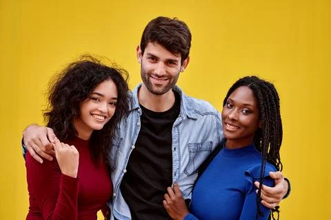 Multi-ethnic friends looking at camera and smiling while posing together. 스톡 사진