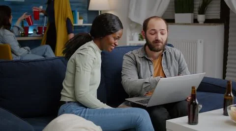 Multi-ethnic friends socializing while watching online funny videos Stock-Fotos