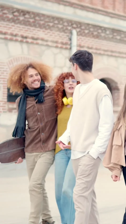 Multi-ethnic friends strolling together relaxed in the city Stock Footage 260850591