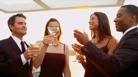 Multi ethnic girls drinking  with men at sunset outdoor party   Stock Footage 11982251