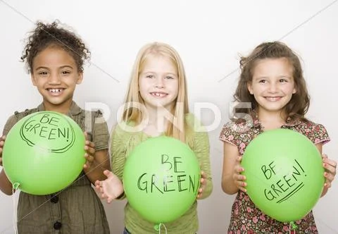 Multi-ethnic girls holding green balloons Stock Photos