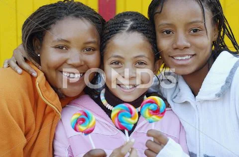 Multi-ethnic girls holding lollipops Stock Photos