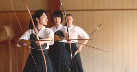 Multi-ethnic group of athletes practicing Japanese traditional Kyudo archery Stock Footage 78078763