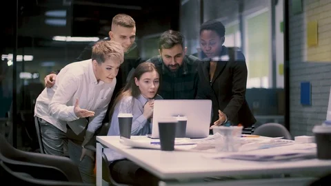 A multi-ethnic group of five businessmen rejoices in the success of their new Stock Footage 120972441