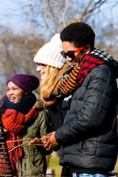 Multi-ethnic group of five young people having fun at barbecue Stock Photos