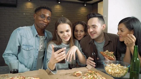 Multi-ethnic group of friends looking at smartphone talking laughing Stock Footage 122744311