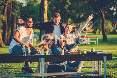 Multi-ethnic group of friends taking a selfie with cellphone. Stock Photos
